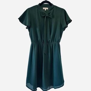 Forest green dress with short sleeves, bow tie, and elastic waist.